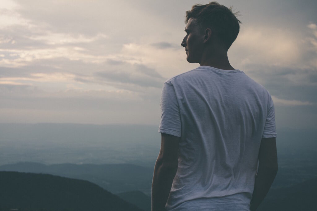 Man standing looking out at horizon