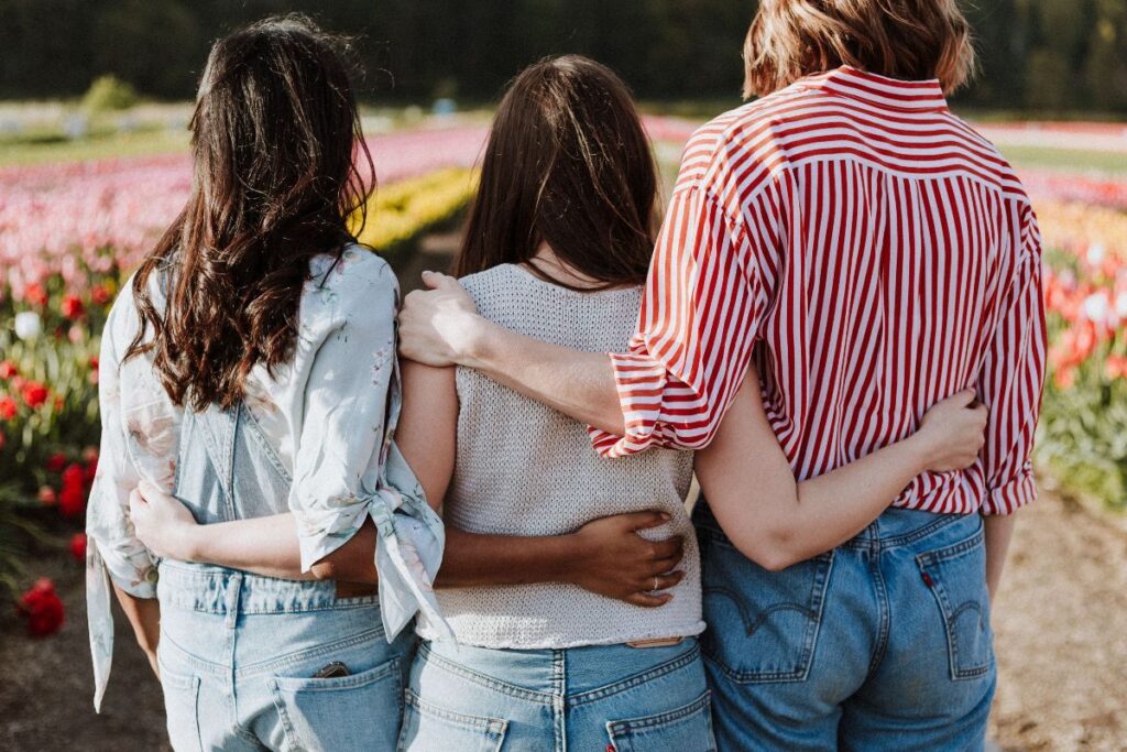 Three friends hugging