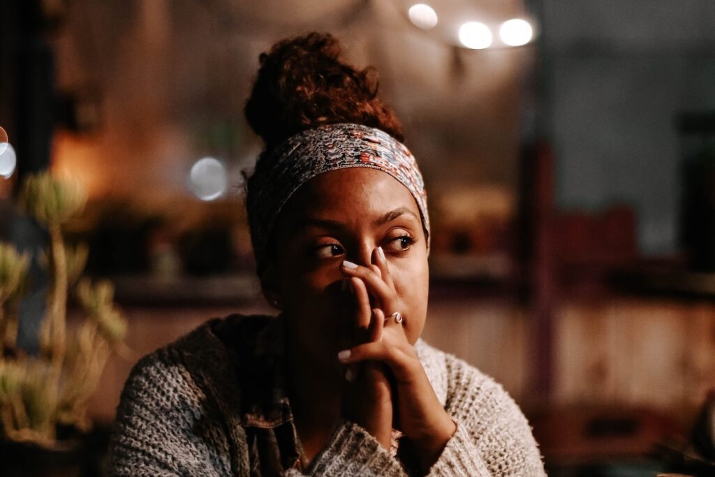 Woman with hands in front of face