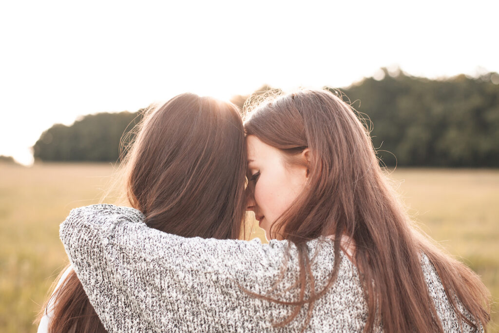 Two friends hugging