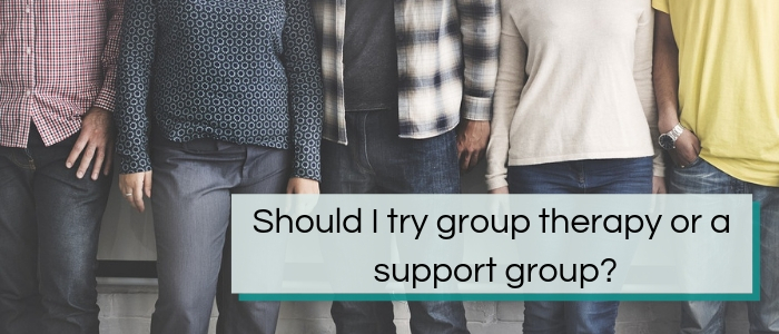 Close-up of four people standing together, only visible from their mid-chest down