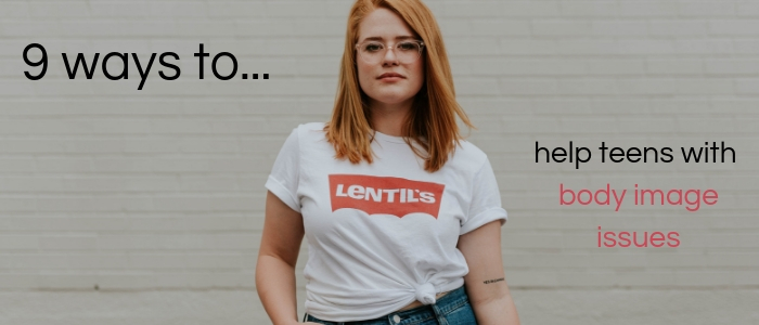 A young woman stands against a plain white backdrop, looking confident in herself