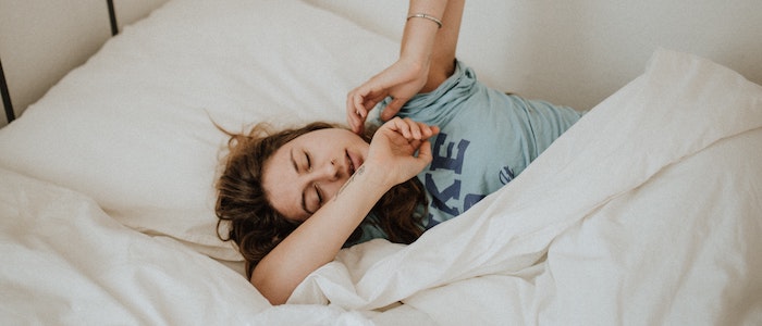 Young Woman Laying in Bed