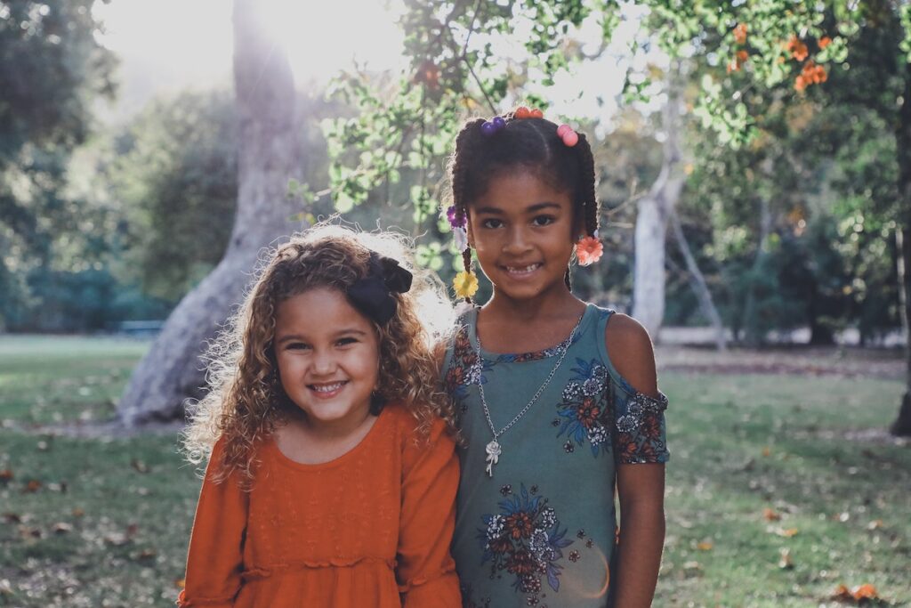 Two young girls dressed up in the garden