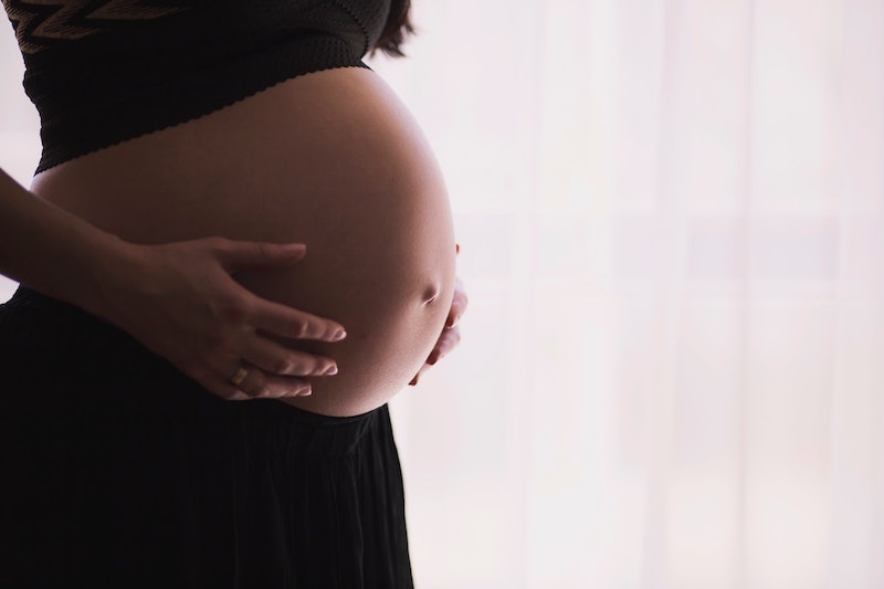 Woman holding her baby bump