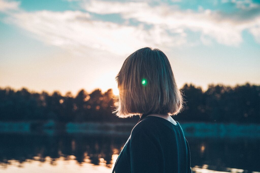 Woman looking out across a lake