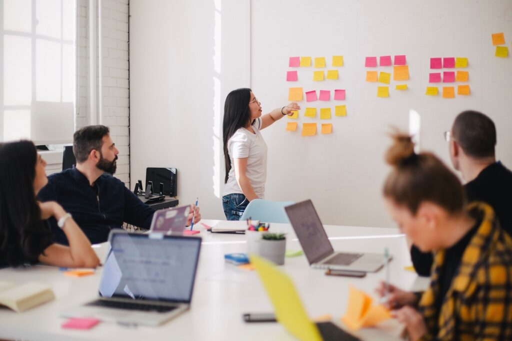 Image of a woman presenting to a team at work