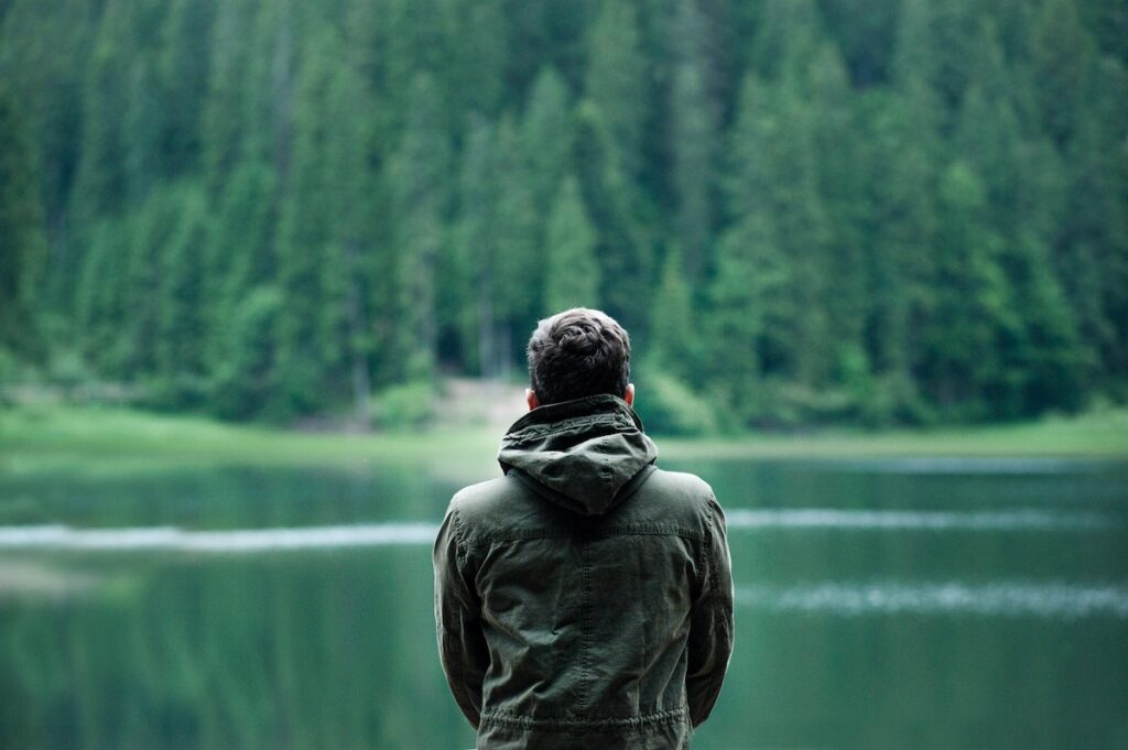 man looking out at water