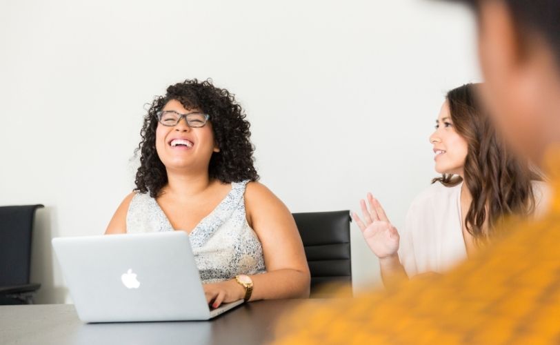 woman laughing in work meeting