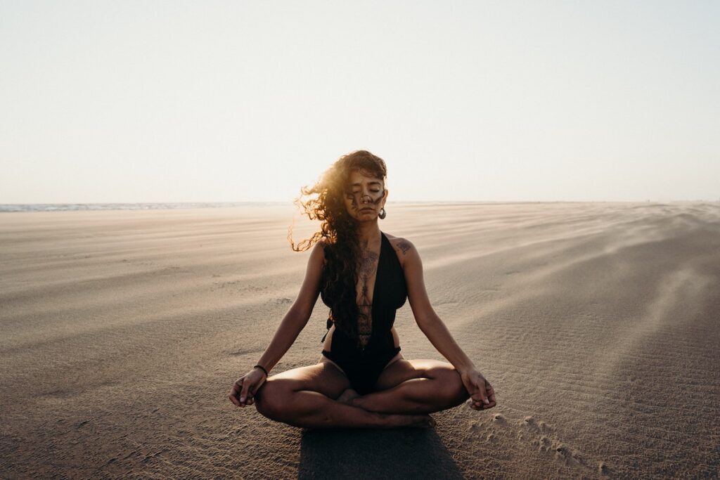 woman meditating in desert