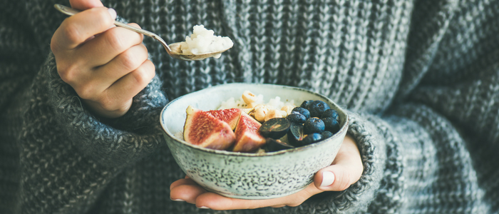 Image of person holding a bowl of fruit