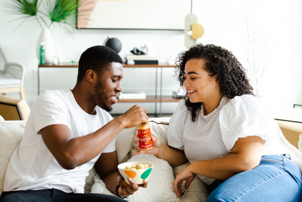 Image of a couple sharing crisps