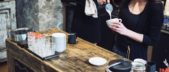 woman pouring milk into coffee - weight gain