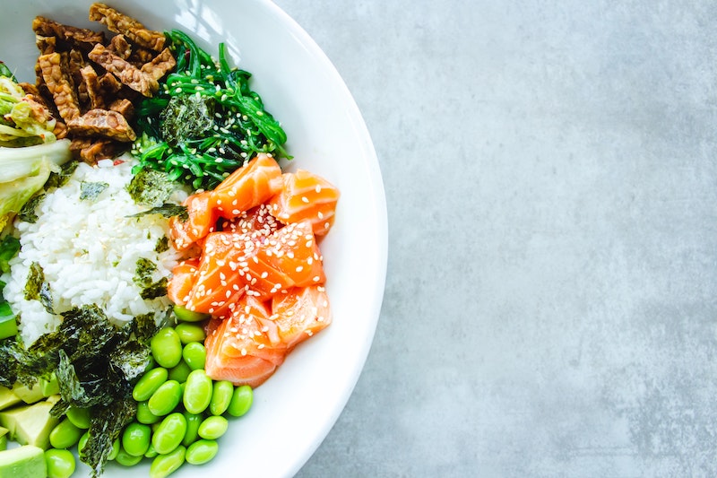 Image of a colourful Poke bowl of beans, kale and salmon