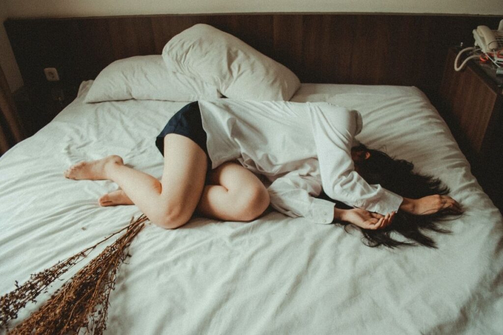 Woman lying on bed with lavender