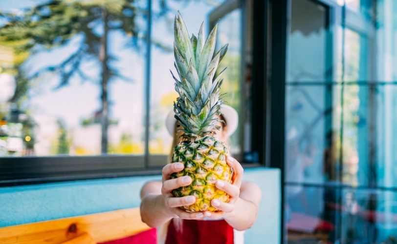 Woman holding pineapple