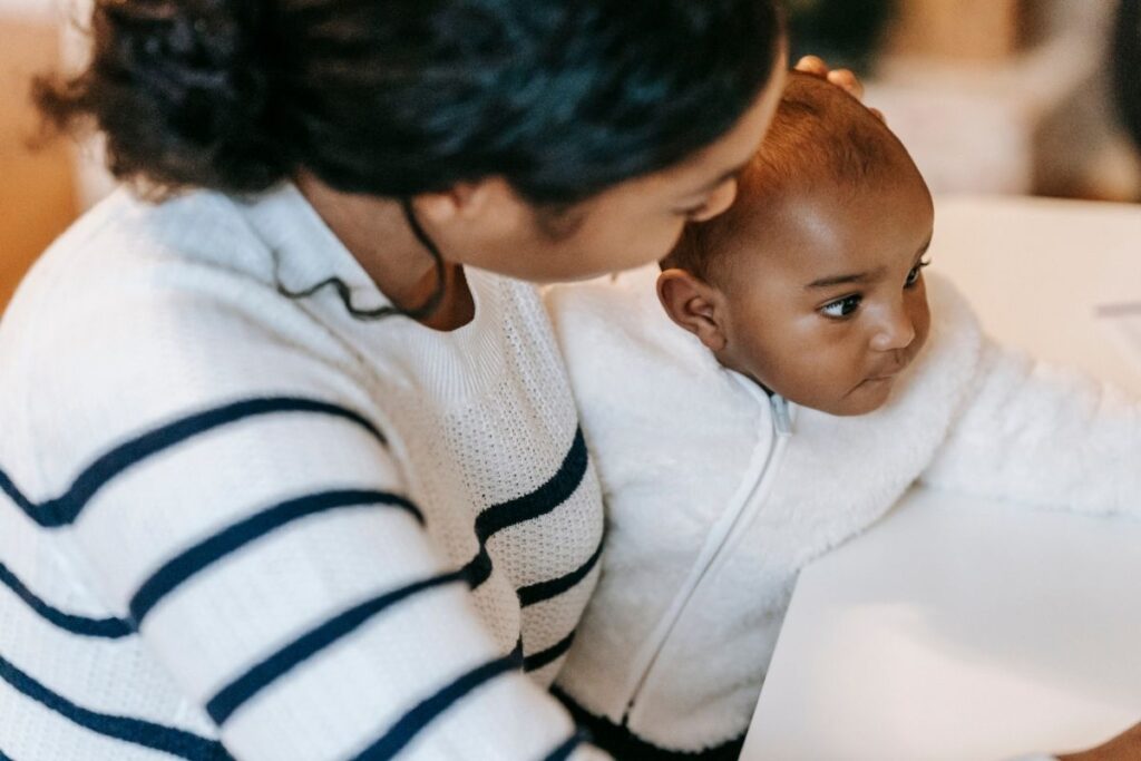 Mother holding baby at dinnertable