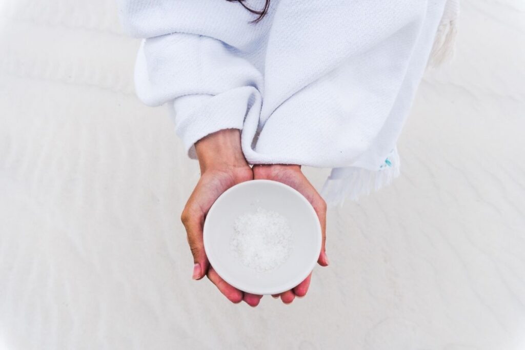 Woman holding bowl of salt