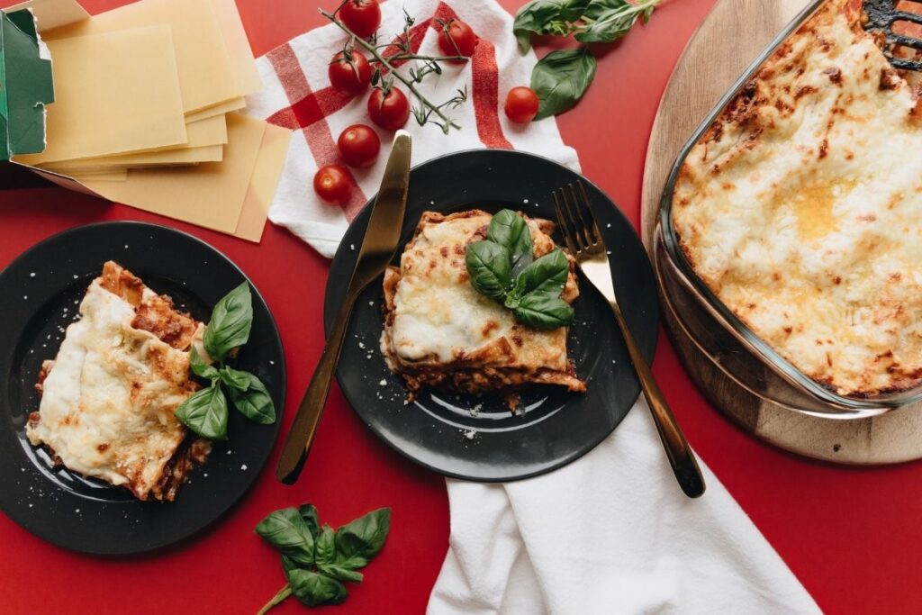 Two plates of lasagne on table