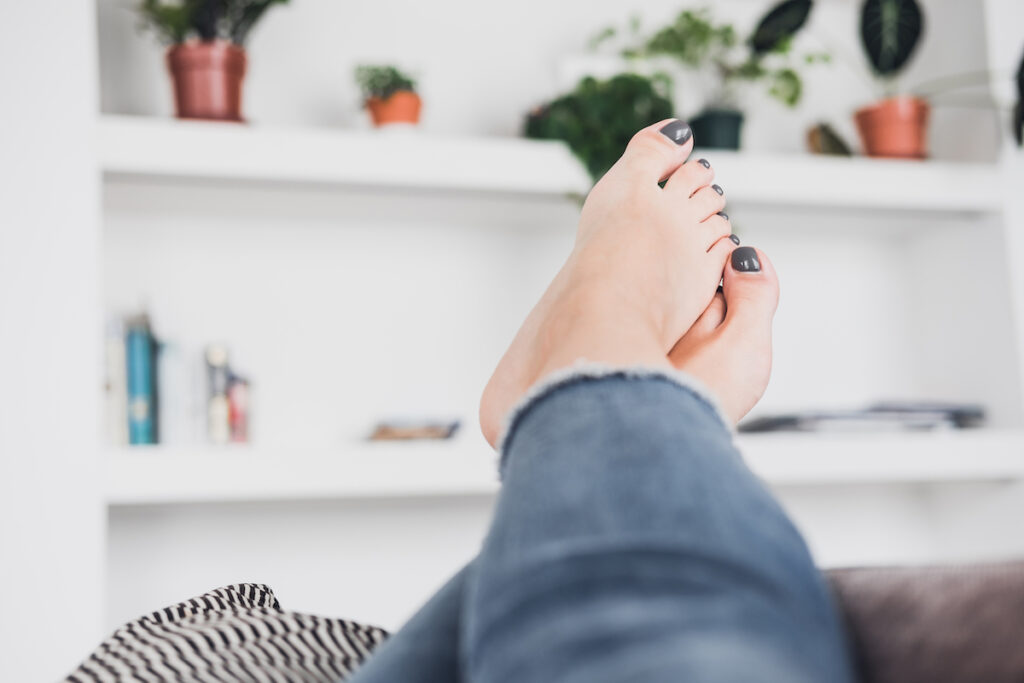Woman at home with feet up