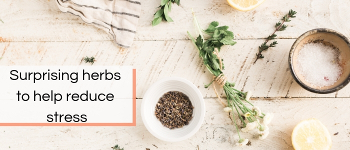 Herbs and lavender lay on a workbench, waiting to be crushed with a pestle and mortar