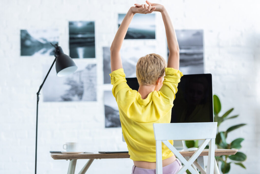 Woman stretching at desk