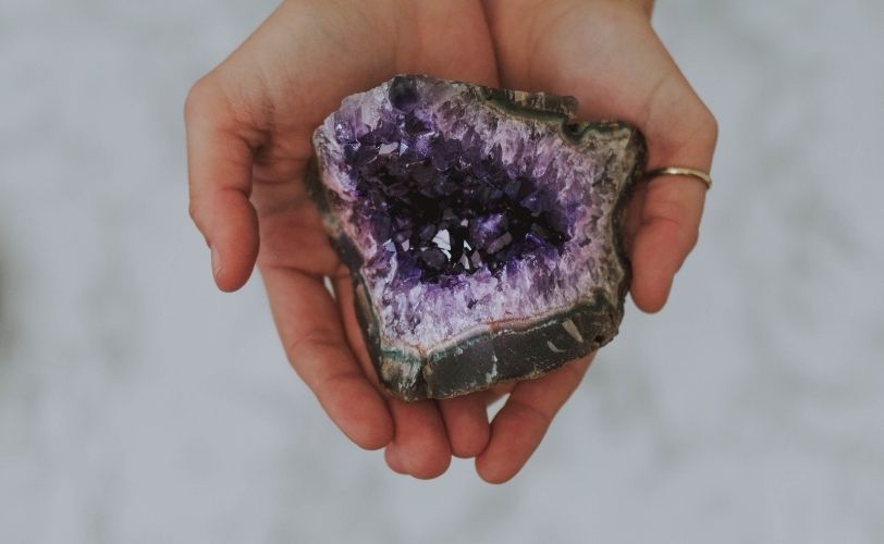 A person holding amethyst