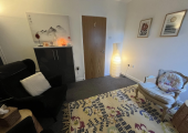 Therapy Rooms in showing chairs rug and soft lighting.