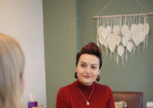 A counsellor sits attentively in a warm, calming therapy room in North London