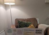 Image of therapist holding out infographics on neurodivergence