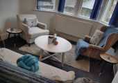 Seating area in my counselling space, with two armchairs and a sofa
