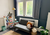 Cosy therapy room with soft lighting and big windows overlooking trees