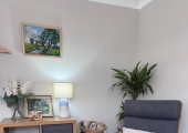My therapy room is a calm, comfortable space with soft lighting and natural touches.