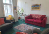 It is a spacious room where it is possible to be sit, be still or to find movement, if this feels interesting and needed.