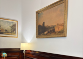 The waiting room for therapy with me in Bank, includes a green suede sofa with antique paintings.