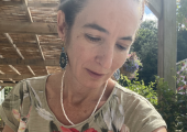 This is an image of a woman creating an artwork outdoors