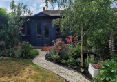 Garden room nestled between trees and plants