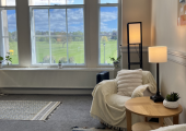 this is a counselling room with two chairs and view out of a window