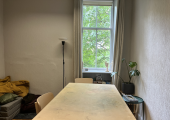 this is a counselling room with a table and two chairs and view out of a window