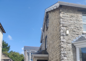View of the building, entrance is behind stone porch