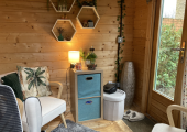 A cabin with 2 chairs, cupboard and desk