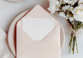 This is an image of Love Leadership - Let your love flourish as an envelope is opened next to a bunch of flowers