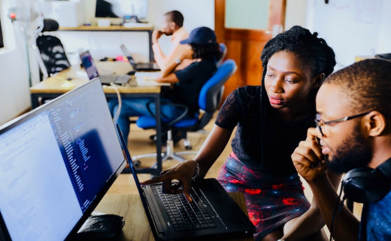Man and woman at computer in office