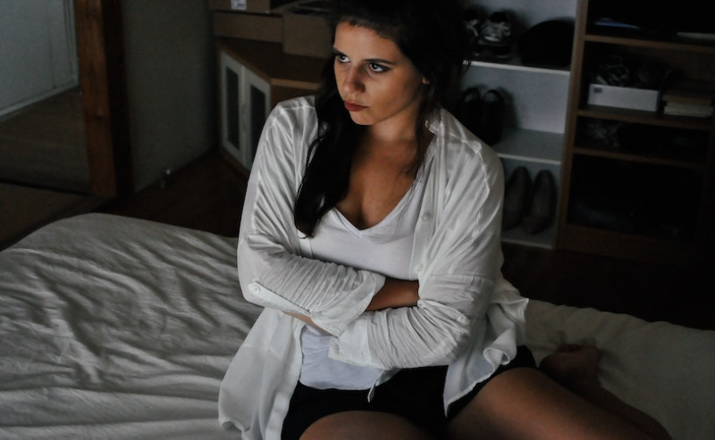 Woman sitting on bed