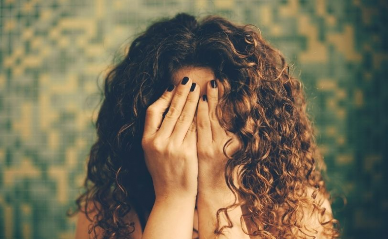 Woman hiding face