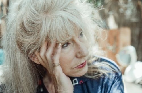 older woman looking sad