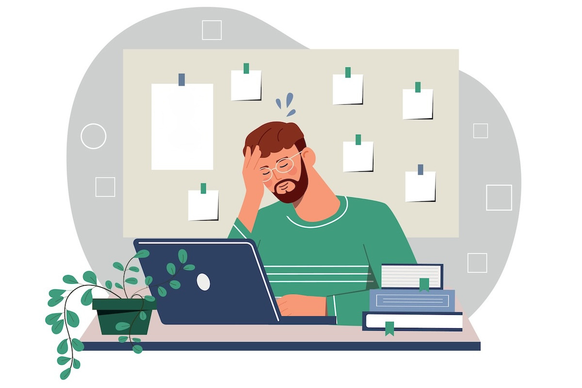 Man overwhelmed sat at desk