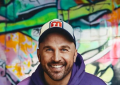 Andy Selway-Woolley, a hypnotherapist based in Bicester, Oxfordshire, smiles in a purple hoodie standing against a vibrant graffiti background, with the text 'Getting You Out of Your Own Way!!'. The image represents the transformative power of soluti