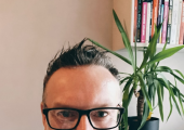 Dan Firth, a male, sat in his office