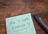 Am I good enough? written on a sticky note
